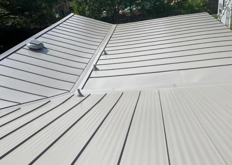 Solar attic fan installed on a metal roof for Roof Ventilation in Thomson